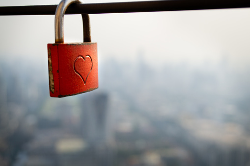 Padlock on the background of the cityscape. View from Baiyoke Sky Tower formerly highest building in Bangkok, Thailand