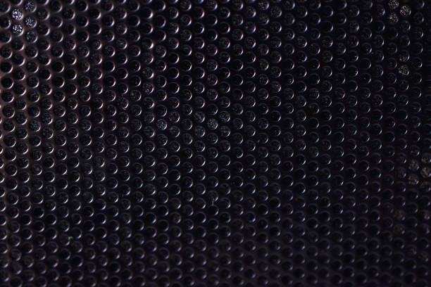 istock Black background made of iron grating with small round holes 1309963414