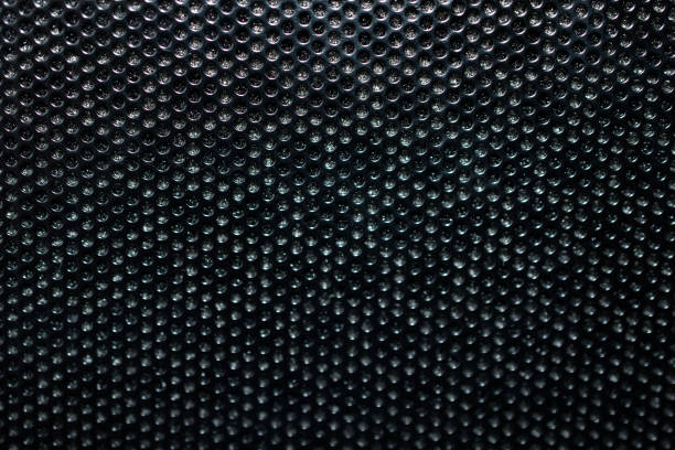 istock Black background made of iron grating with small round holes 1309963441