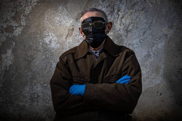 istock An old man,protesting against the Corona repression wearing several masks on his face 1309963558