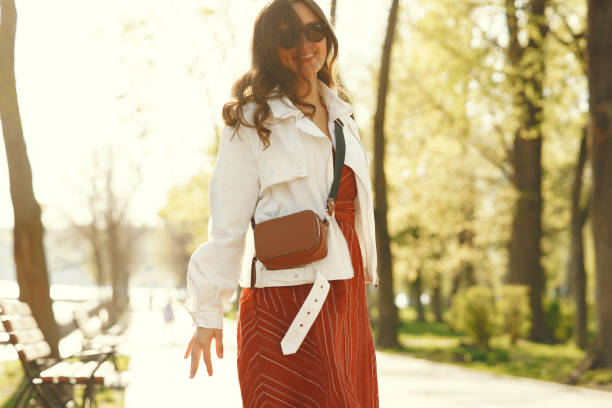 istock Stylish woman spending time in a spring park 1309963737