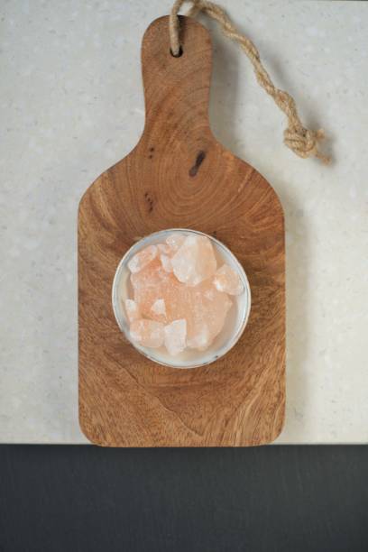 himalayan pink salt in gray cup on board on marble background.pink crystal salt - salt crystal spoon food imagens e fotografias de stock