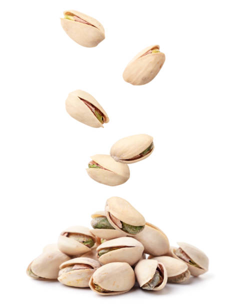 istock Pistachios fall on a heap on a white background. Isolated 1309966032