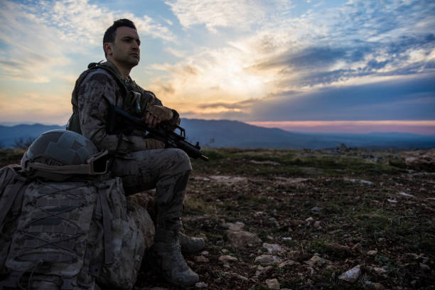 istock Army Soldier in the battlefield at sunset 1309967409