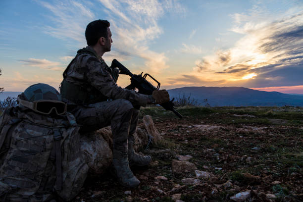 istock Army Soldier in the battlefield at sunset 1309967416