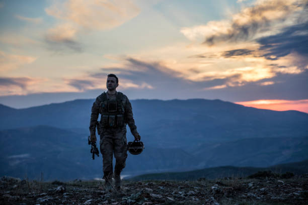 istock Army Soldier walking at sunset 1309967419