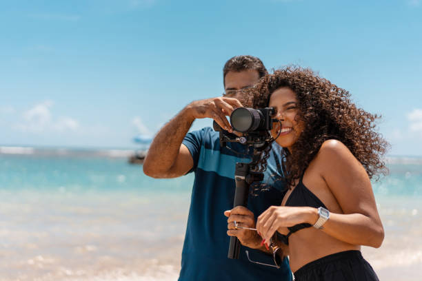 istock Young woman looking through the photographer's camera 1309967934