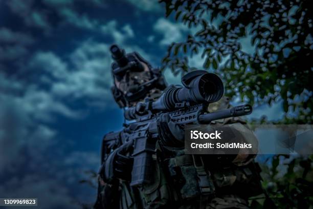 The Soldier Is Holding A Weapon With A Telescopic Sight View From The Lower Angle Night Vision Device In The Dark Stock Photo - Download Image Now