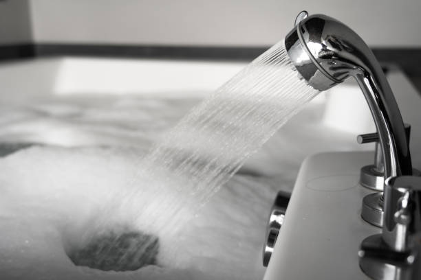 istock Filling water into bathtub - relaxation concept. 1309969919