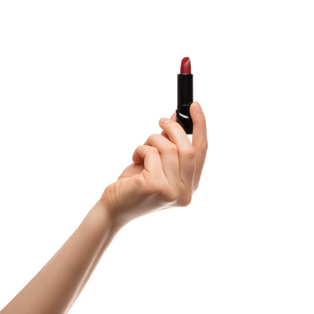 istock Red lipstick in a woman's hand on a white background, isolated. 1309970178
