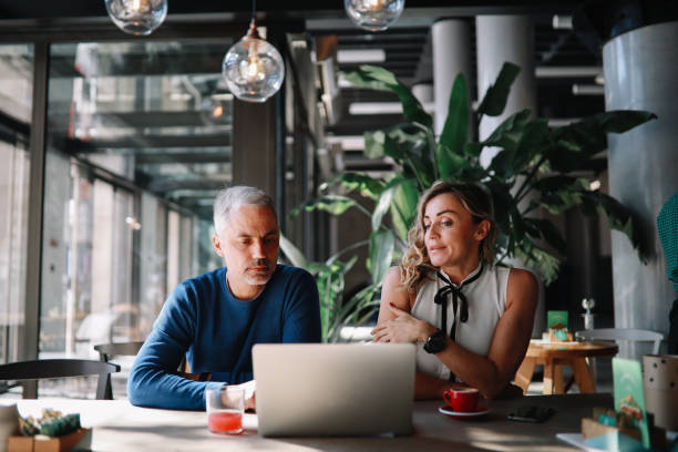 istock Coworkers discussing work in the office 1309970240