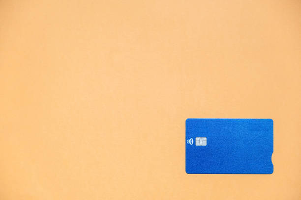 istock A blue credit card on an orange background with a large copy space 1309970371