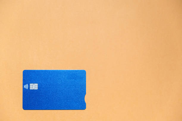 istock A blue credit card on an orange background with a large copy space 1309970401