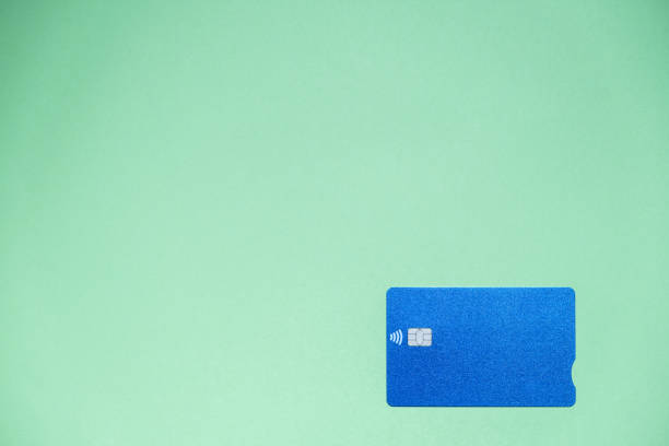 istock A blue credit card on a light green background with a large copy space 1309970404