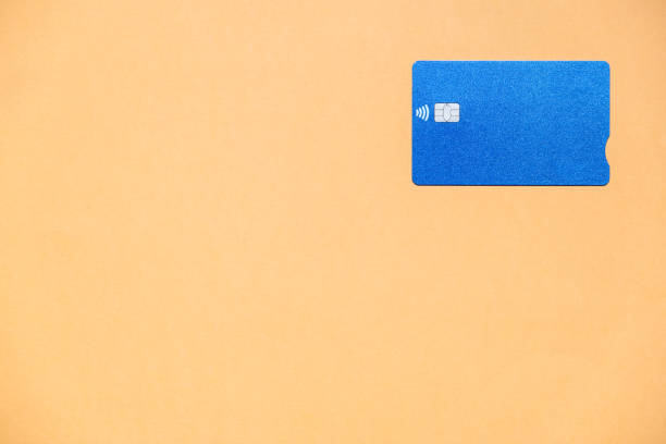 istock A blue credit card on an orange background with a large copy space 1309970405