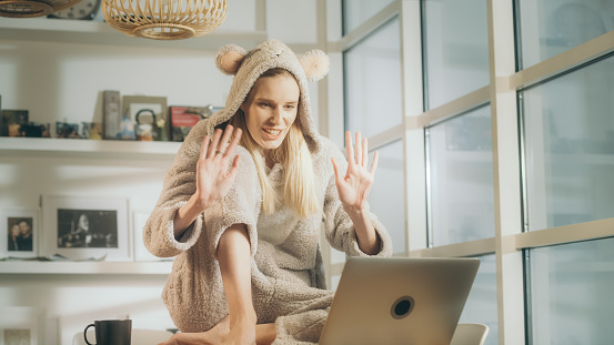 Online meeting during pandemic. Young woman enjoying online date with her friend