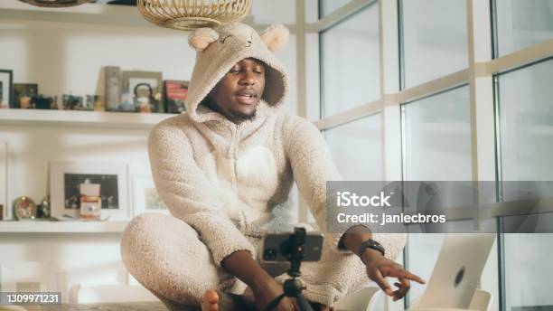 Missing A Friend During Lockdown African Man Doing Video Call In Cute Bear Onesie Using Smart Phone Stock Photo - Download Image Now