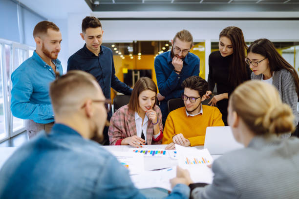 istock Group of young businesspeople working together in creative office. 1309972972