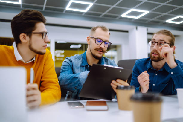 istock Group of young businesspeople working together in creative office. 1309972973