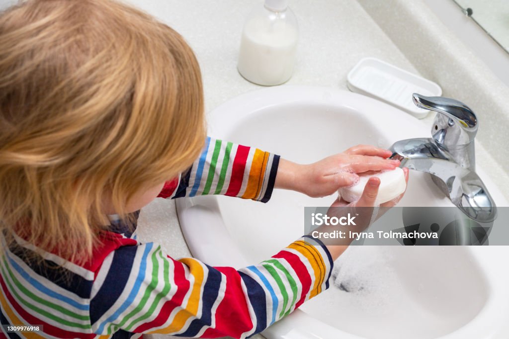 Child washing hands with soap in the bathroom Little child washing hands with soap in the bathroom Washing Hands Stock Photo