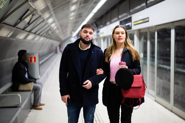 istock Young man with girlfriend walking on underground station 1309978340