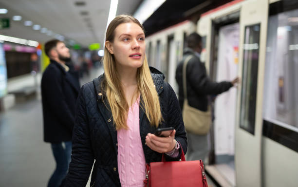 istock Woman using phone at underground station 1309978344
