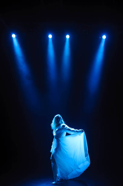 istock Attractive plus size model posing on dark background in the rays of lights. 1309978350