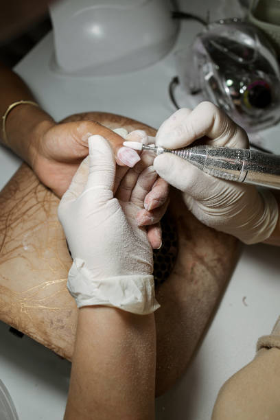istock mechanical process of shellac removal. Women's manicure 1309979042
