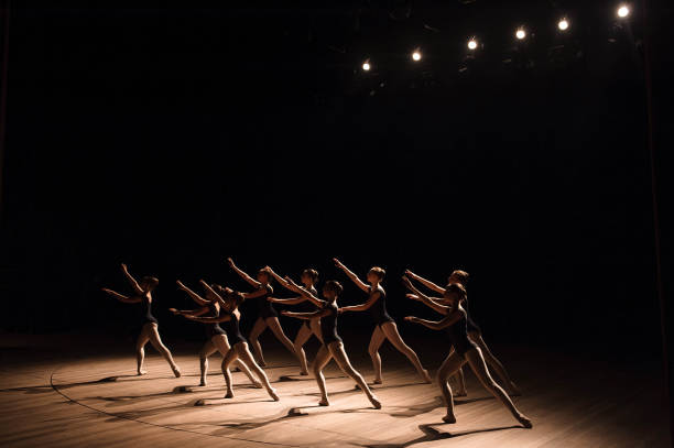 a choreographed dance of a group of graceful pretty young ballerinas practicing on stage in a classical ballet school. - round bale imagens e fotografias de stock