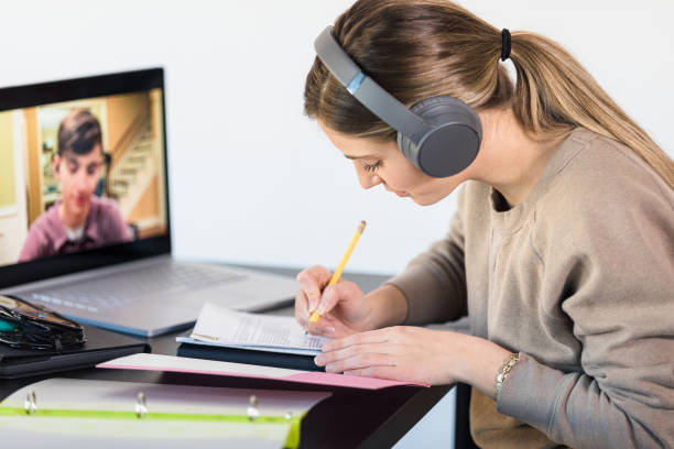 istock Friends get together via video conferencing to work on homework 1309981728