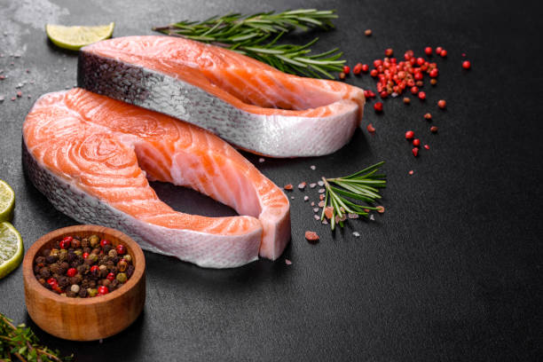 istock Fresh raw salmon steak with spices and herbs prepared for grilled baking 1309982811