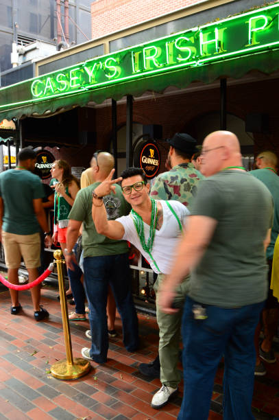 Party time at an Irish pub Los Angeles, CA, USA March 17 A young man shows his party side at a St Patrick's Day celebration in Los Angeles photo bomb stock pictures, royalty-free photos & images