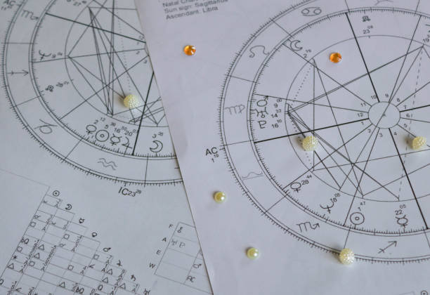istock Printed astrology birthcharts with white and orange sequins 1309984251