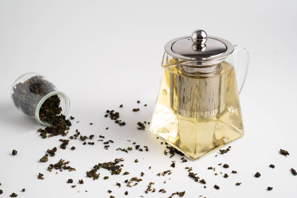 White tea in a transparent glass teapot. Refreshing white tea. Brewed white tea
