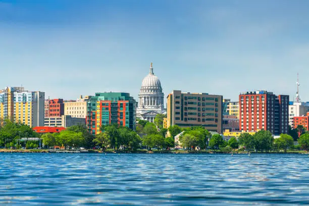 Madison, Wisconsin, USA downtown skyline on Lake Monona in the daytime.