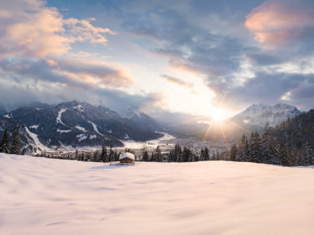 istock Beautiful romantic winter covered landscape in the Alps during sunset 1309987671