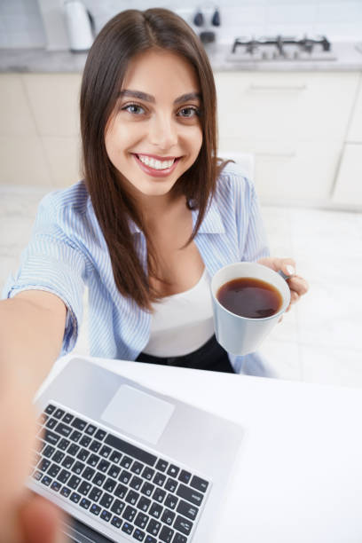 istock Young woman working and drinking tea. 1309987673