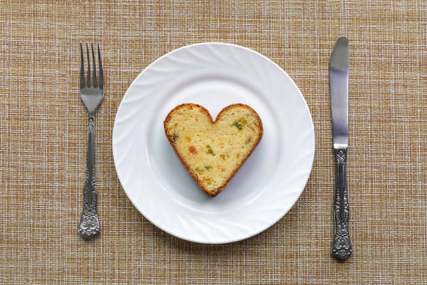 istock White plate with one cupcake in form of heart on surface, where serving fork and knife 1309989962