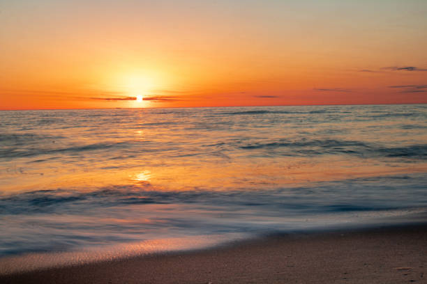 istock Sunrise over the horizon at the beach 1309990938
