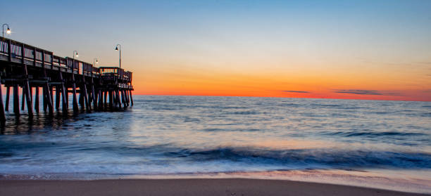 Sandbridge Pier in Virginia Beach at sunrise stock photo