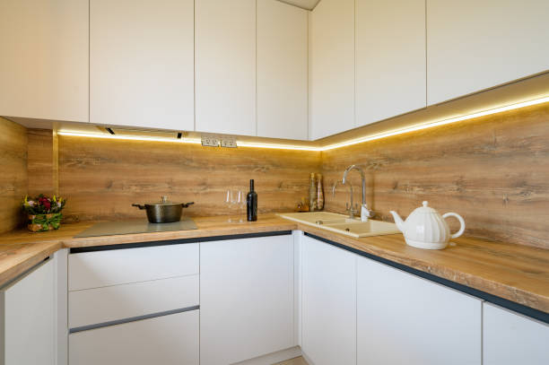istock Modern white and beige wooden kitchen interior details 1309994096
