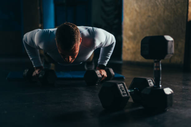 istock Man doing pushups in the gym 1309994466
