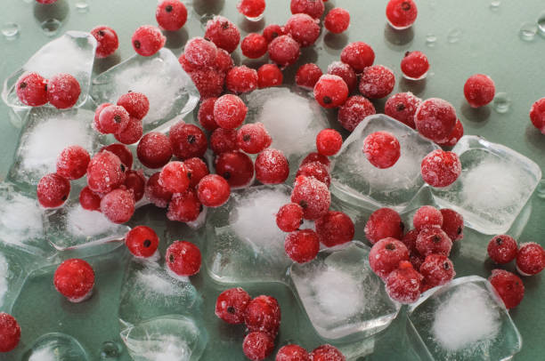 istock frozen ripe red currant on ice cubes on green background.ingredients for a cold summer drink 1309995391