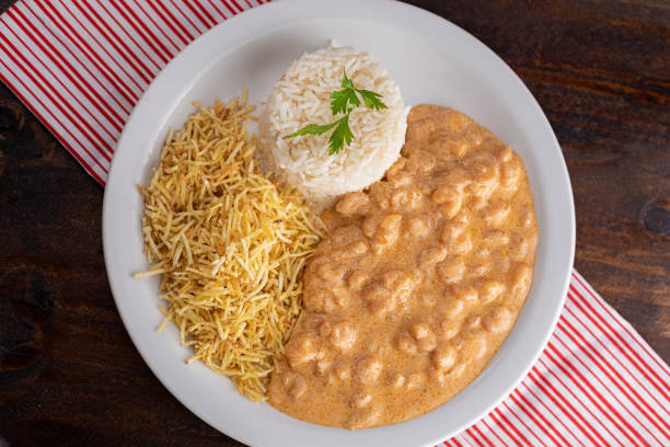 istock Meals - Done Dish - Shrimp stroganoff with straw potatoes and rice 1309995679