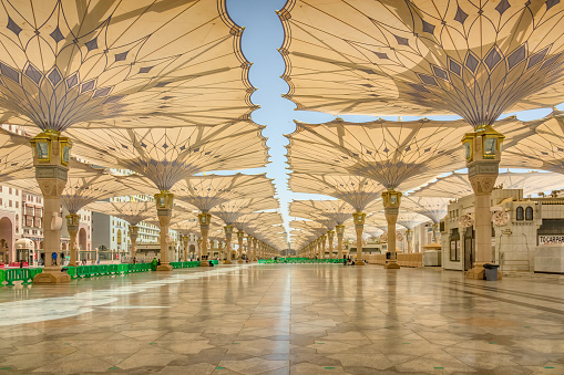 Courtyard of the Al Haram or Al-Masjid an-Nabawi mosque in Medina Saudi Arabia on a sunny day. It was the second mosque built by Muhammad in Medina and is now one of the largest mosques in the world.