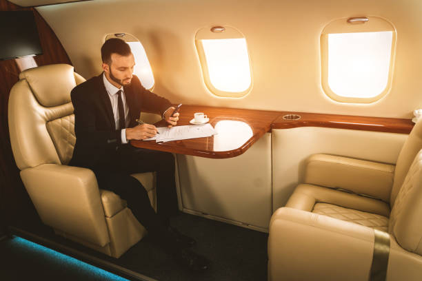 istock Businessman flying on private jet 1309996511