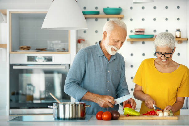 Mature couple cooking lunch together.