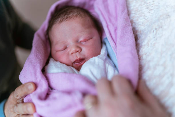 istock Grandmas Snuggling Newborn 1309999012