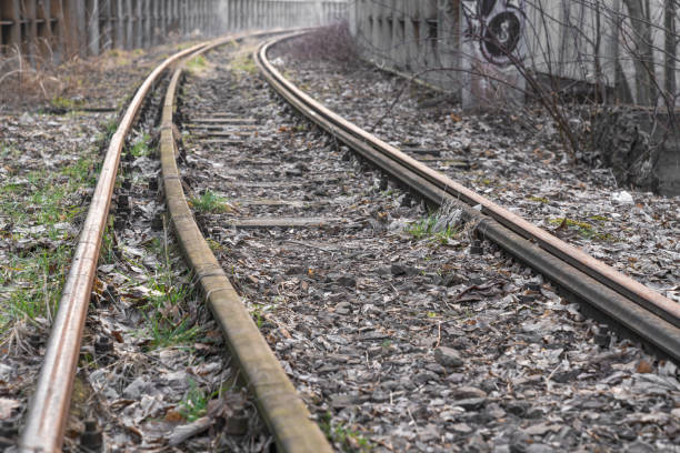 istock Old abandoned train station with rusty railroad tracks 1309999094