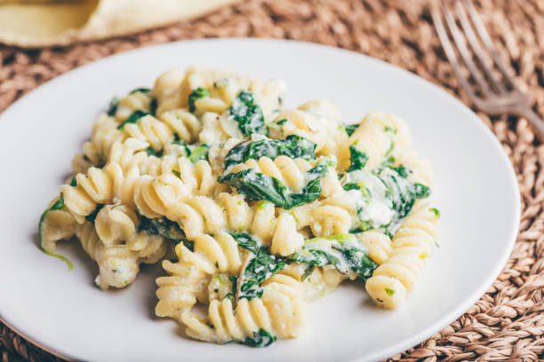 Creamy Pasta with Spinach and Thyme Creamy Pasta with Spinach and Thyme on White Plate spinach pasta stock pictures, royalty-free photos & images